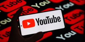 youtube-logo-on-smartphone-against-youtube-logos-background.jpg